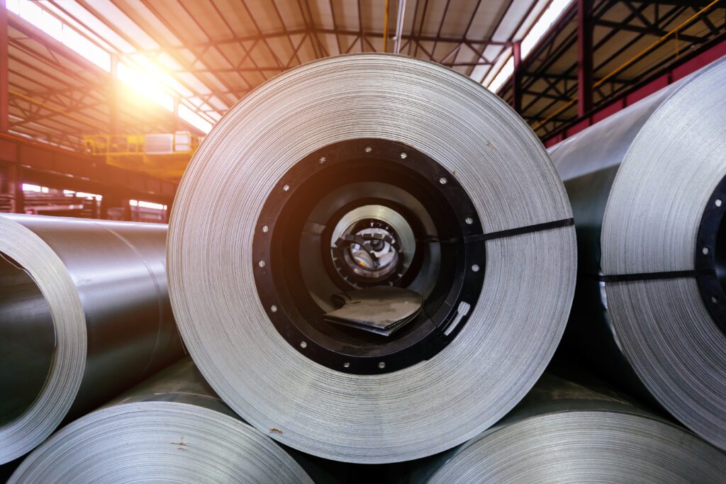 Rolls of galvanized steel sheet inside a factory warehouse for metal fabrication